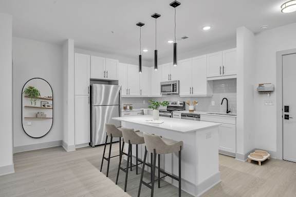 A modern kitchen with white cabinets and a central island