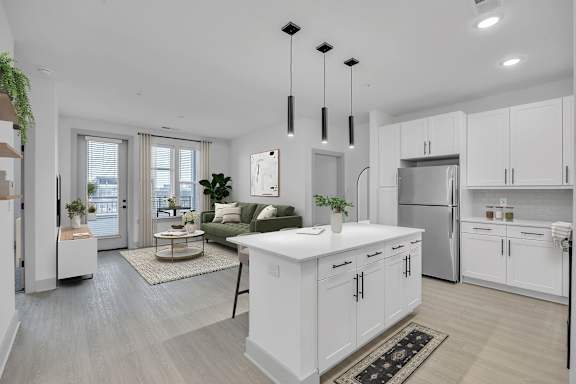 A modern kitchen with white cabinets and a large island