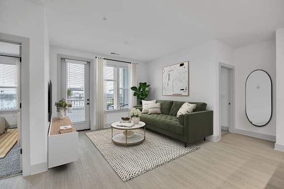 A modern living room with a green sofa and a coffee table