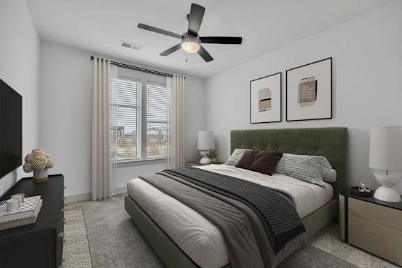 A bedroom with a large bed and a ceiling fan