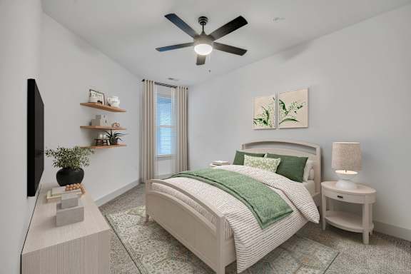 A bedroom with a bed, a ceiling fan, and a television