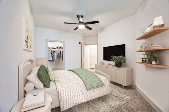 A bedroom with a bed, a ceiling fan, and a cabinet