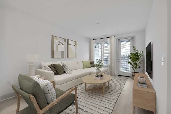A living room with a couch, chair, and television.