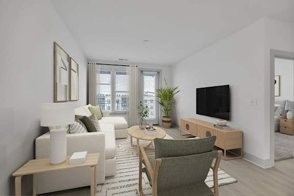 A living room with a green chair and a white couch