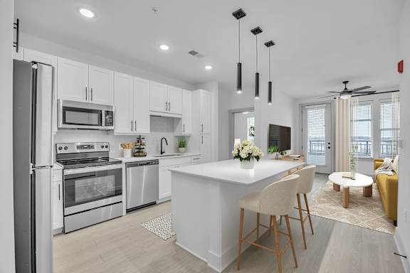 A modern kitchen with a large island and a dining area