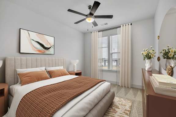 A bedroom with a large bed and a ceiling fan