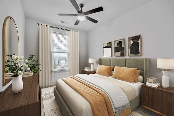 A bedroom with a large bed, a mirror, and a ceiling fan