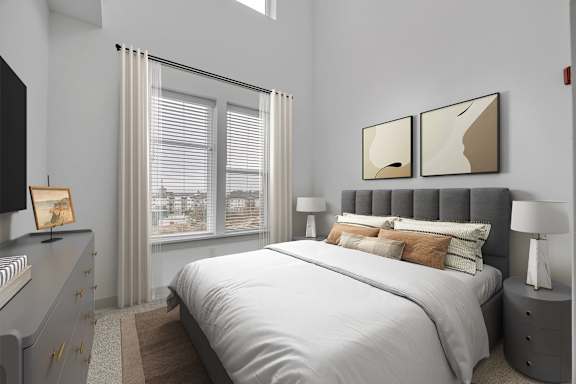 A bedroom with a large bed, a dresser, and two framed pictures on the wall