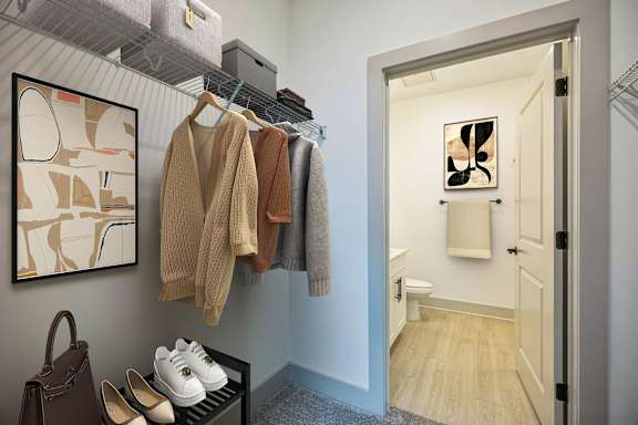 A hallway with a coat rack and a painting on the wall