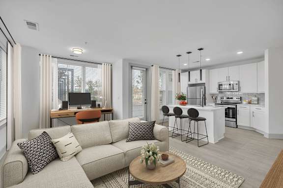 A modern living room with a grey sofa and a coffee table