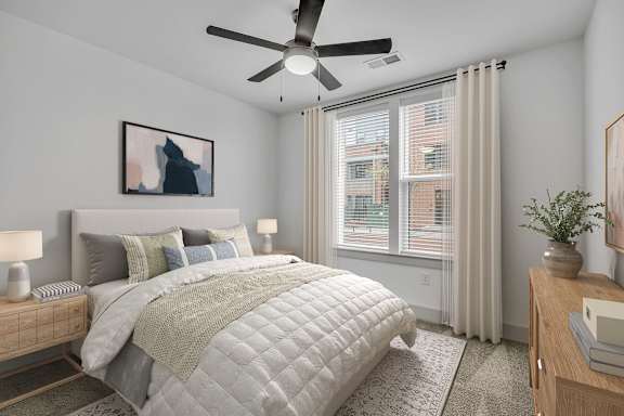A bedroom with a large bed and a ceiling fan