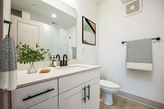 A bathroom with a white toilet and a white sink