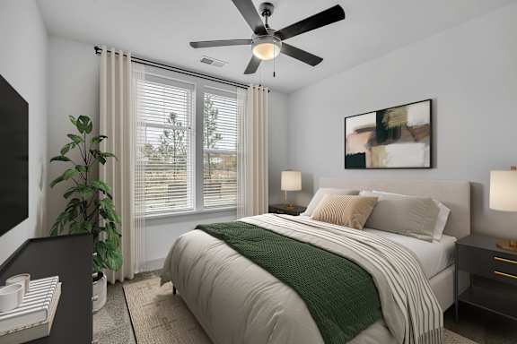 A bedroom with a large bed and a ceiling fan