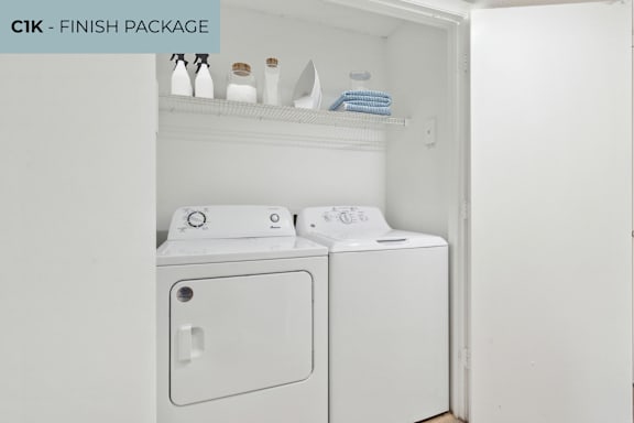 A white washing machine and dryer are in a cabinet.