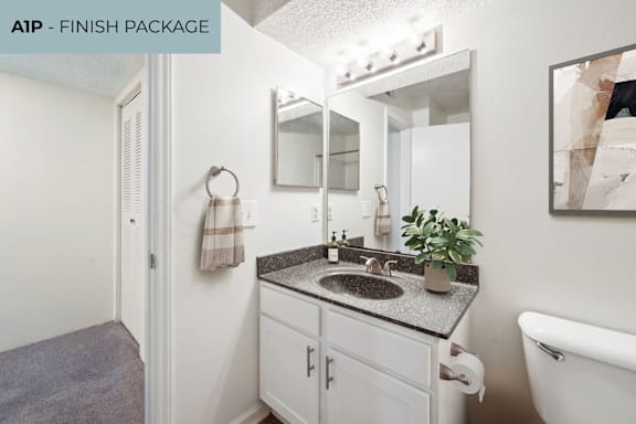 A small bathroom with a sink and mirror.