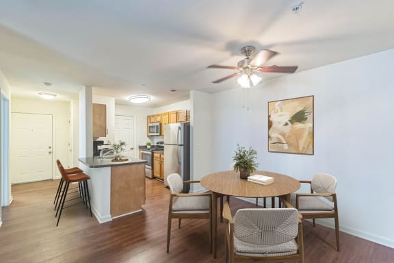 a living room with a dining room table and a kitchen at Sanger Place, Lorton, VA, 22079