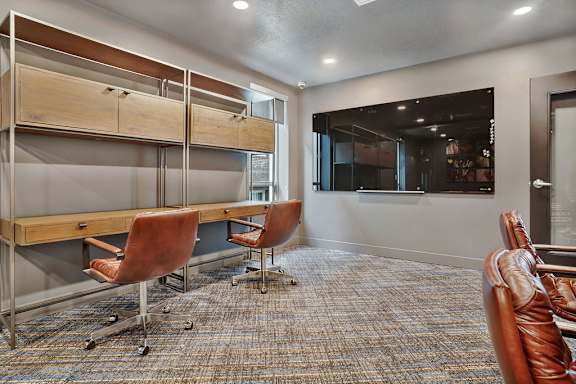 A room with a long table and chairs.