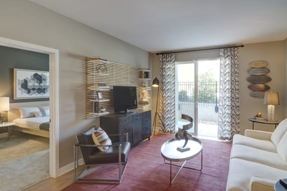 a living room with a couch and a table and a television at Fort Totten Square, Washington DC