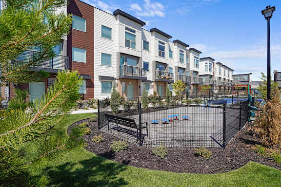 Apartment complex with a playground in front.