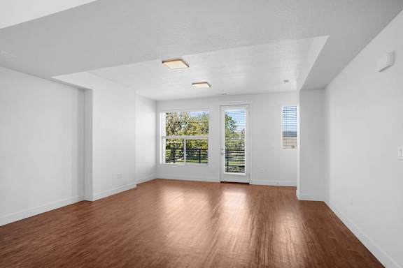 A room with wooden floors and white walls.