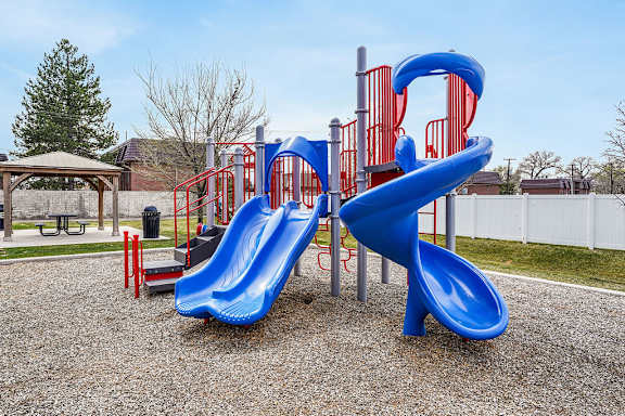 A blue slide in a playground.