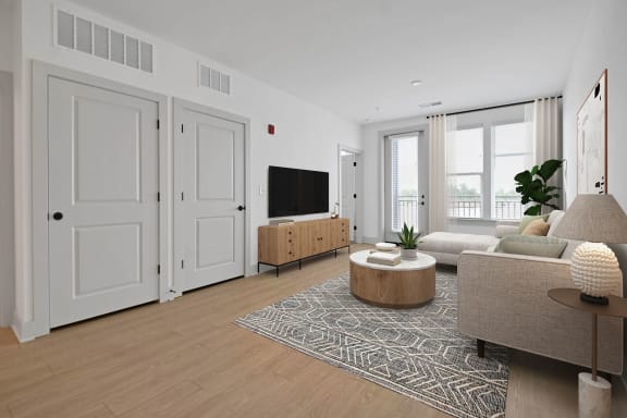 a living room with a couch and a tv at Metropolitan at the Riverwalk, Wilmington, NC