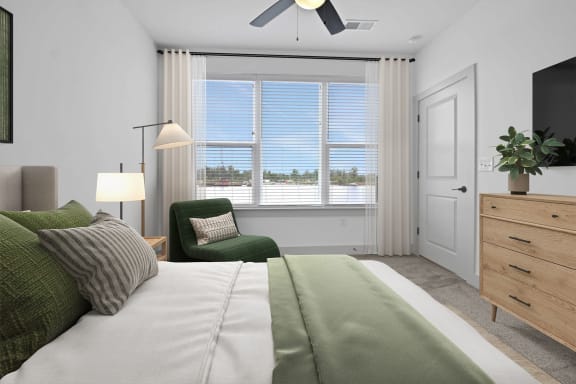 a bedroom with a bed and a window at Metropolitan at the Riverwalk, Wilmington, NC