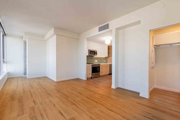 A kitchen area with a refrigerator, oven, and microwave.