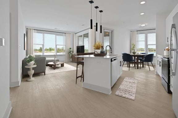 an open kitchen and living room with a table and chairs at Metropolitan at the Riverwalk, Wilmington, NC