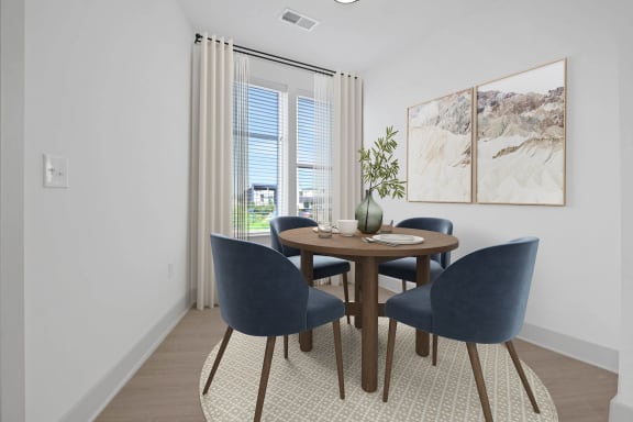 a dining room with a table and chairs and a window at Metropolitan at the Riverwalk, Wilmington, NC