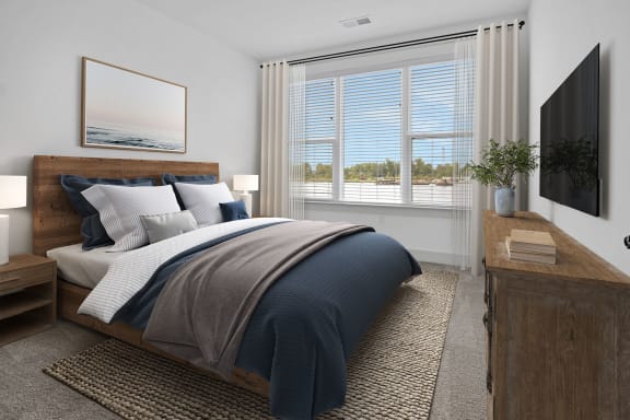 a bedroom with a bed and a window at Metropolitan at the Riverwalk, Wilmington, NC