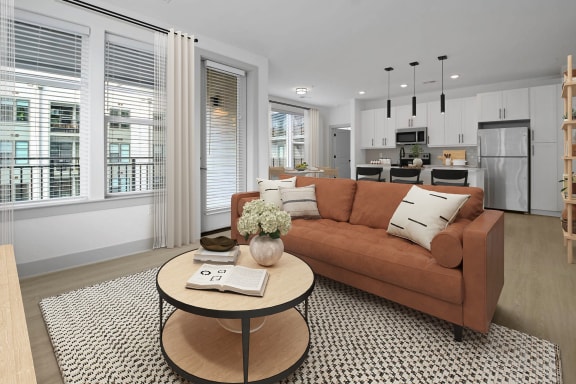 a living room with a brown couch and a coffee table at Metropolitan at the Riverwalk, Wilmington, NC