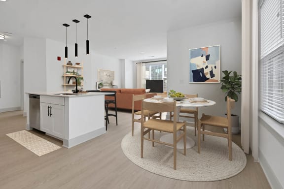 a living room and dining room with a table and chairs at Metropolitan at the Riverwalk, Wilmington, NC
