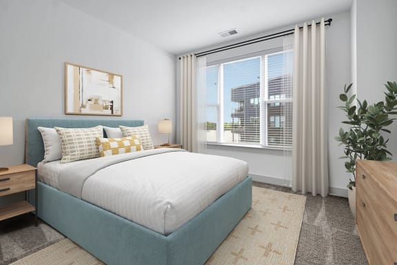 a bedroom with a bed and a large window at Metropolitan at the Riverwalk, Wilmington, NC
