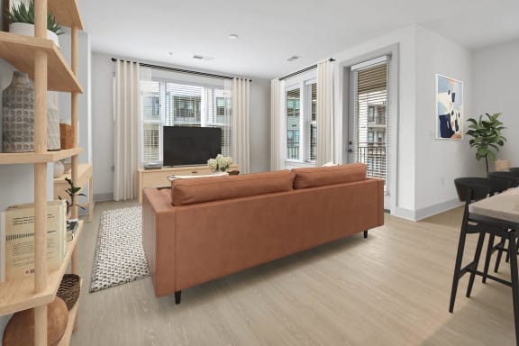 a living room with a couch and a tv at Metropolitan at the Riverwalk, Wilmington, NC