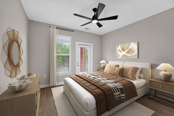 A bedroom with a large bed and a ceiling fan.