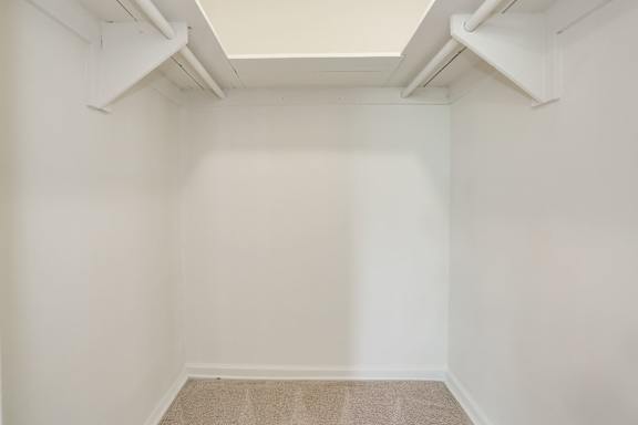 A room with a carpeted floor and white walls.