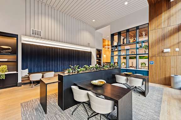 A modern dining area with a dark table and chairs.
