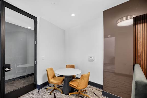 A conference room with a table and chairs.