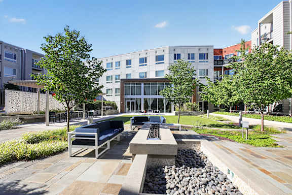A modern building with a courtyard in front of it.