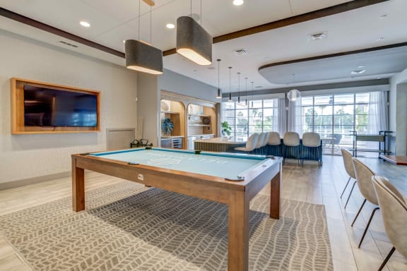 a games room with a pool table and a flat screen tv at Delamarre at Celebration, Celebration, FL 34747