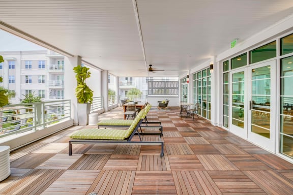 a large porch with wood floors and glass doors at Delamarre at Celebration, Florida