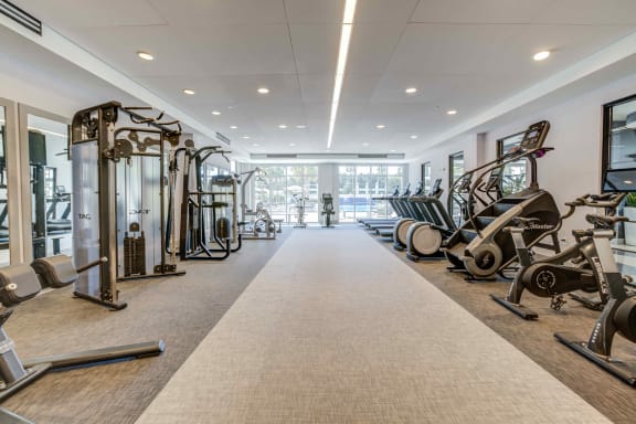 fitness center with cardio equipment at the bradley braddock road station apartments at Delamarre at Celebration, Florida, 34747