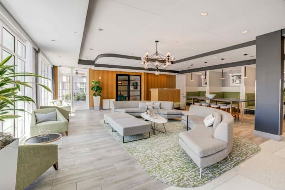 a living room filled with furniture and a chandelier at Delamarre at Celebration, Celebration