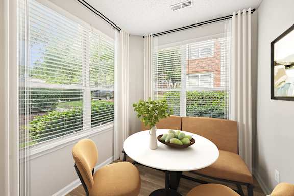 A dining room with a table and chairs.