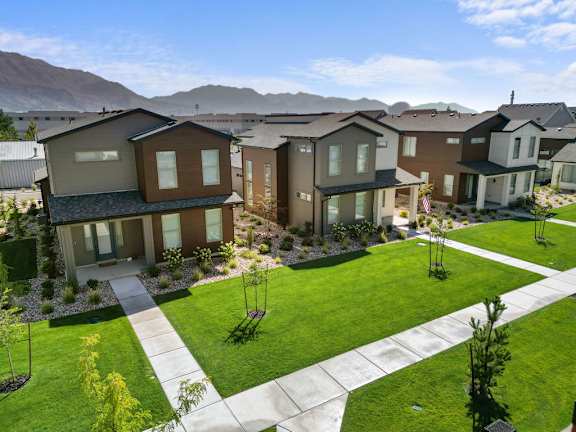 A row of houses with a mountain in the background.