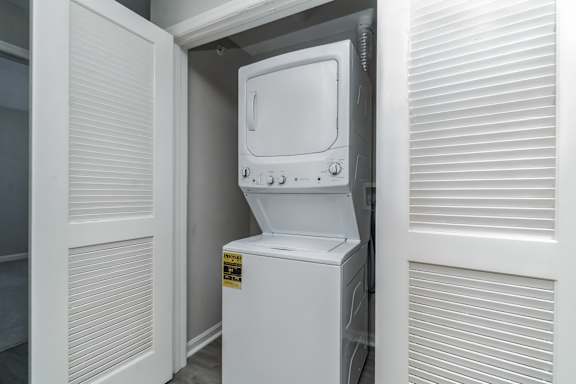 A white dishwasher is tucked into a kitchen cabinet.