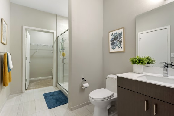 a bathroom with a toilet sink and shower in a 555 waverly unit at Delamarre at Celebration, Celebration, 34747