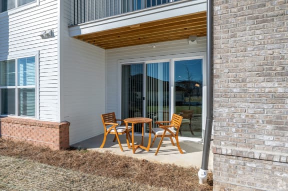 a patio with a table and chairs outside of a house at Fairmont at South Lake, Bowie, 20716