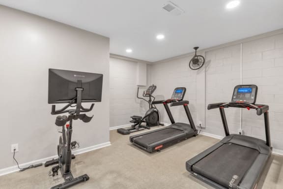 the gym in the owners suite is equipped with exercise equipment and a tv  at Brampton Moors, Cary, NC